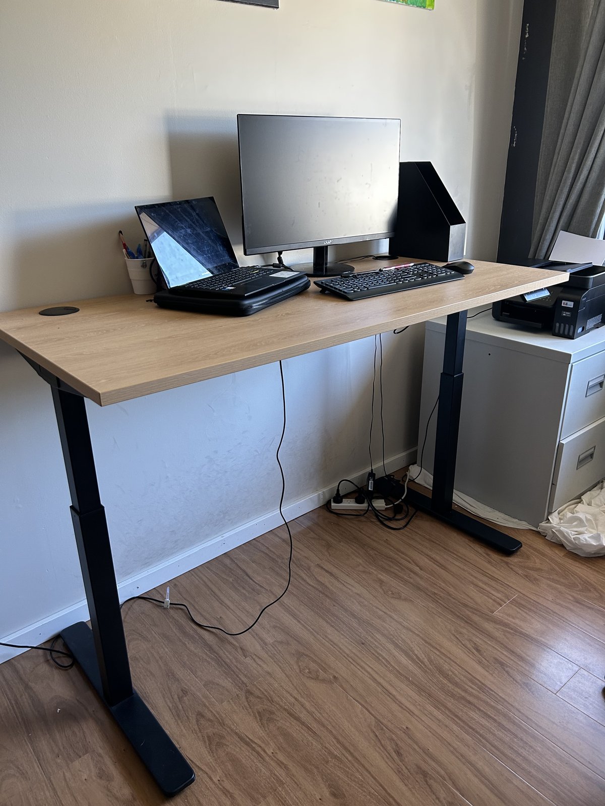 Compact sit-stand desk in a small room